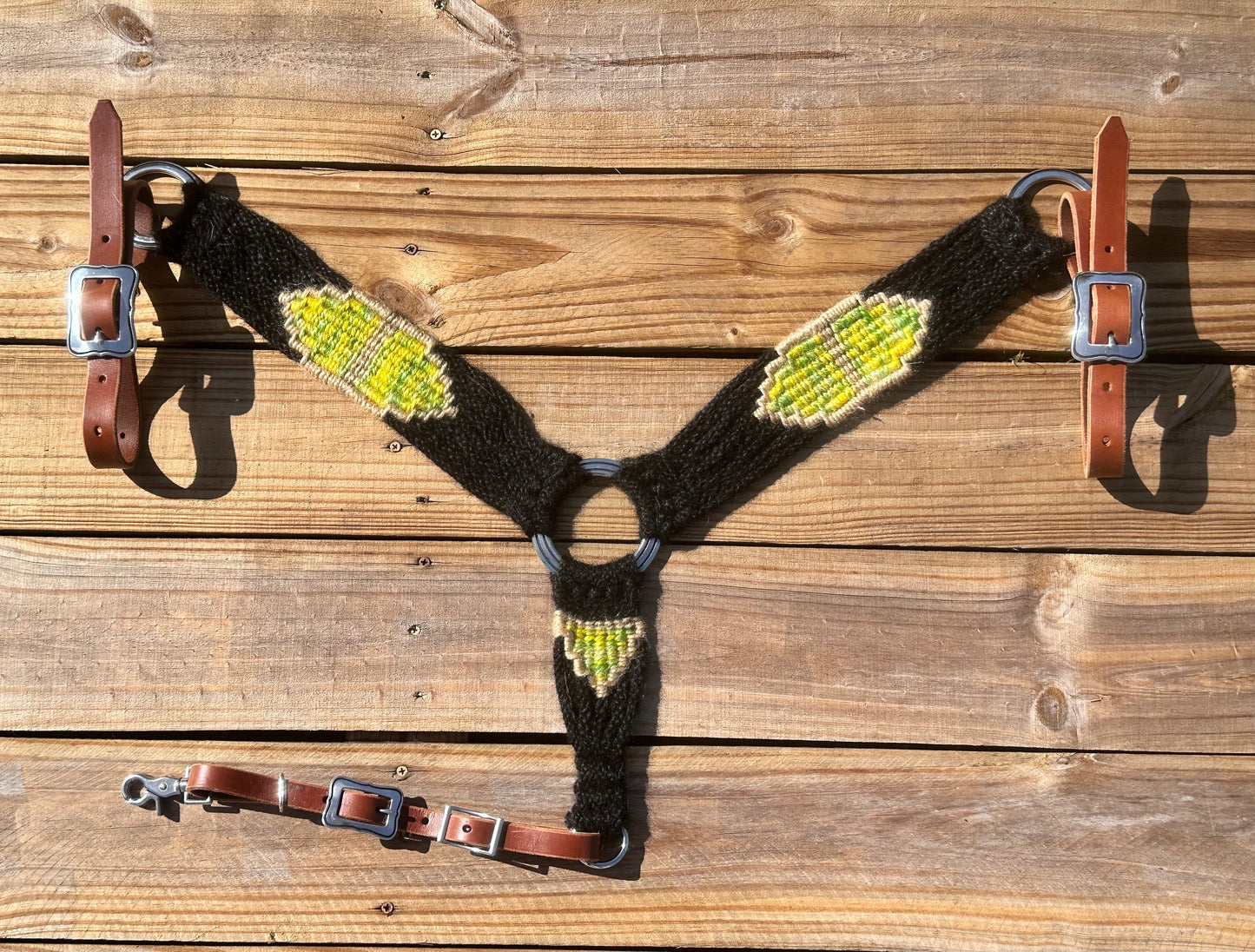 Black, yellow, and green breast collar