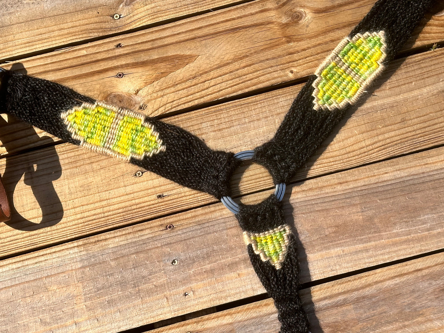Black, yellow, and green breast collar