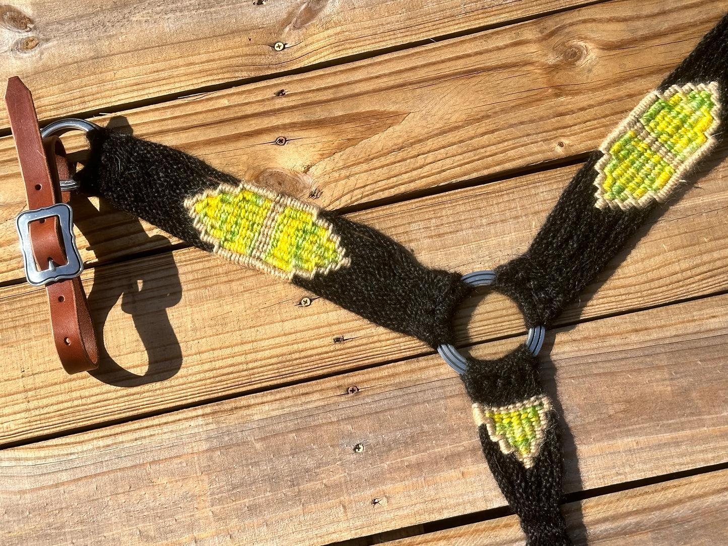 Black, yellow, and green breast collar